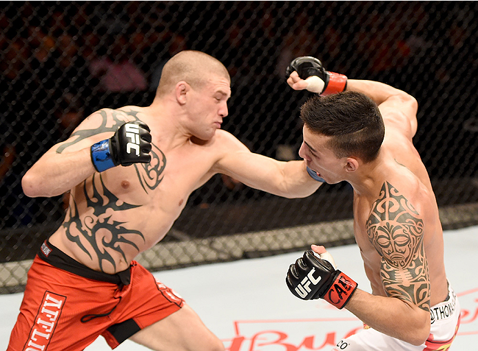 UBERLANDIA, BRAZIL - NOVEMBER 08: Tim Gorman of the United States punches Thomas Almeida of Brazil in their bantanweight bout during the UFC Fight Night at Sabiazinho Gymnasium on November 8, 2014 in Uberlandia, Brazil. (Photo by Buda Mendes/Zuffa LLC/Z