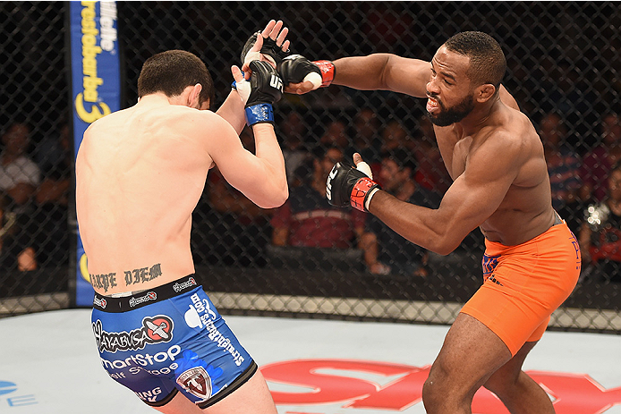 UBERLANDIA, BRAZIL - NOVEMBER 08: Leandro Silva of Brazil punches Charlie Brenneman of the United States in their lightweight bout during the UFC Fight Night at Sabiazinho Gymnasium on November 8, 2014 in Uberlandia, Brazil. (Photo by Buda Mendes/Zuffa