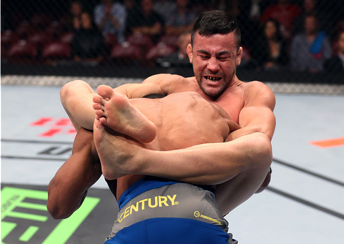 HALIFAX, NS - OCTOBER 4: (L-R) Pedro Munhoz of Brazil locks in a guillotine submission against Jerrod Sanders in their bantamweight bout at the Scotiabank Centre on October 4, 2014 in Halifax, Nova Scotia, Canada. (Photo by Nick Laham/Zuffa LLC/Zuffa LLC