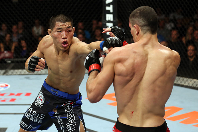 HALIFAX, NS - OCTOBER 4: (L-R) Li Jingliang of China punches Nordine Taleb of Canada in their welterweight bout at the Scotiabank Centre on October 4, 2014 in Halifax, Nova Scotia, Canada. (Photo by Nick Laham/Zuffa LLC/Zuffa LLC via Getty Images)