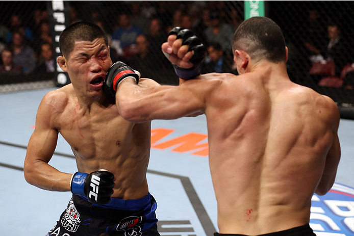 HALIFAX, NS - OCTOBER 4: (R-L) Nordine Taleb of Canada punches Li Jingliang of China in their welterweight bout at the Scotiabank Centre on October 4, 2014 in Halifax, Nova Scotia, Canada. (Photo by Nick Laham/Zuffa LLC/Zuffa LLC via Getty Images)