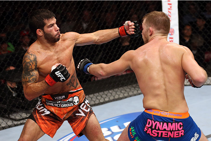 HALIFAX, NS - OCTOBER 4: (L-R) Raphael Assuncao of Brazil punches Bryan Caraway in their bantamweight bout at the Scotiabank Centre on October 4, 2014 in Halifax, Nova Scotia, Canada. (Photo by Nick Laham/Zuffa LLC/Zuffa LLC via Getty Images)