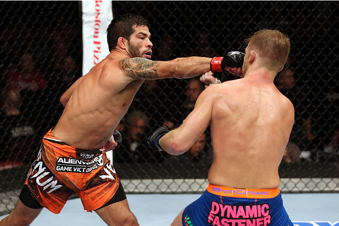 HALIFAX, NS - OCTOBER 4: (L-R) Raphael Assuncao of Brazil punches Bryan Caraway in their bantamweight bout at the Scotiabank Centre on October 4, 2014 in Halifax, Nova Scotia, Canada. (Photo by Nick Laham/Zuffa LLC/Zuffa LLC via Getty Images)