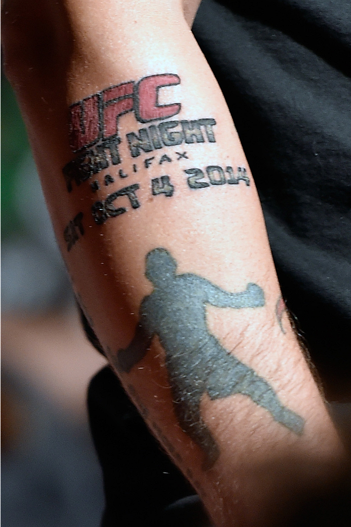 HALIFAX, NS - OCTOBER 3: A detail shot of a fan's tattoo as he interacts with Travis Browne and Jon Anik during a Q&A session before the UFC Fight Night weigh-in at the Scotiabank Centre on October 3, 2014 in Halifax, Nova Scotia, Canada. (Photo by Jeff