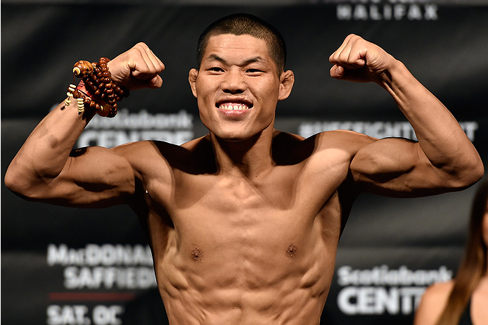 HALIFAX, NS - OCTOBER 3: Li Jingliang of China steps on the scale during the UFC Fight Night weigh-in at the Scotiabank Centre on October 3, 2014 in Halifax, Nova Scotia, Canada. (Photo by Jeff Bottari/Zuffa LLC/Zuffa LLC via Getty Images)