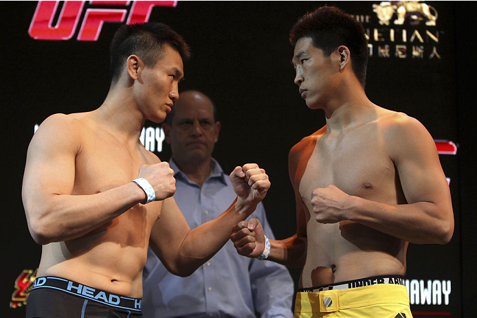 MACAU - FEBRUARY 28: (L and R) Albert Cheng and Wang Anying face off during the UFC weigh-in event at the Venetian Macau on February 28, 2014 in Macau. (Photo by Mitch Viquez/Zuffa LLC/Zuffa LLC via Getty Images)