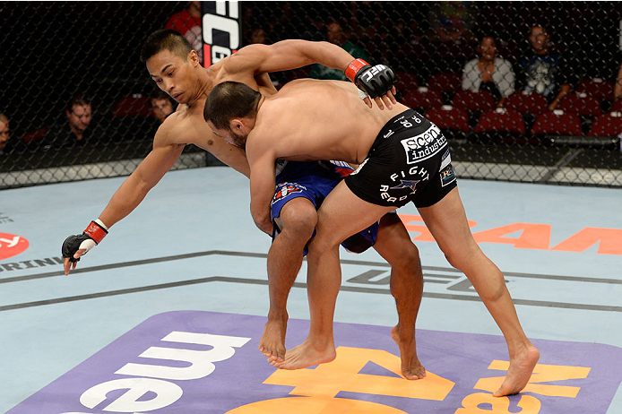 BANGOR, ME - AUGUST 16: (R-L) Frankie Saenz takes down Nolan Ticman in their bantamweight bout during the UFC fight night event at the Cross Insurance Center on August 16, 2014 in Bangor, Maine. (Photo by Jeff Bottari/Zuffa LLC/Zuffa LLC via Getty Images