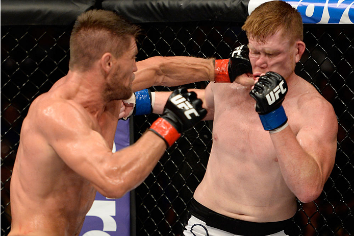 BANGOR, ME - AUGUST 16: (L-R) Tom Watson punches Sam Alvey in their middleweight bout during the UFC fight night event at the Cross Insurance Center on August 16, 2014 in Bangor, Maine. (Photo by Jeff Bottari/Zuffa LLC/Zuffa LLC via Getty Images)