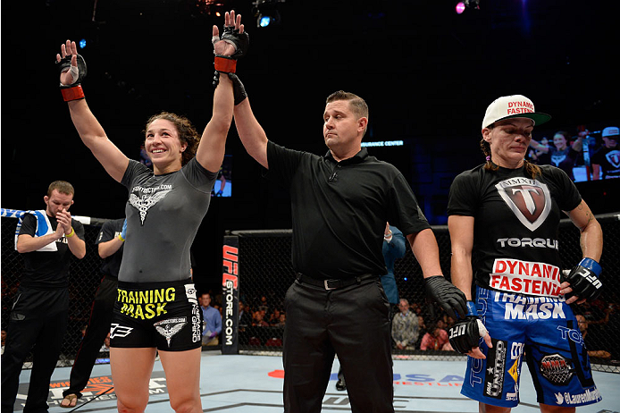 BANGOR, ME - AUGUST 16: (L-R) Sara McMann celebrates after defeating Lauren Murphy in their women's bantamweight bout during the UFC fight night event at the Cross Insurance Center on August 16, 2014 in Bangor, Maine. (Photo by Jeff Bottari/Zuffa LLC/Zuf