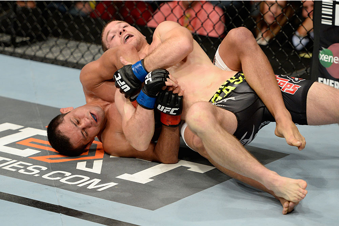 BANGOR, ME - AUGUST 16: (L-R) Jussier Formiga controls the body of Zach Makovsky in their flyweight bout during the UFC fight night event at the Cross Insurance Center on August 16, 2014 in Bangor, Maine. (Photo by Jeff Bottari/Zuffa LLC/Zuffa LLC via Ge