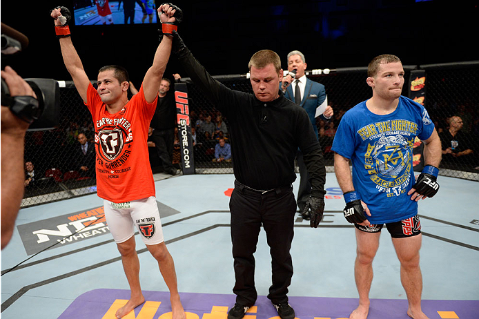 BANGOR, ME - AUGUST 16: (L-R) Jussier Formiga celebrates the split decision win over Zach Makovsky in their flyweight bout during the UFC fight night event at the Cross Insurance Center on August 16, 2014 in Bangor, Maine. (Photo by Jeff Bottari/Zuffa LL
