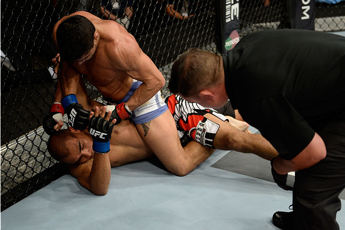BANGOR, ME - AUGUST 16: (R-L) Thiago Tavares controls the body of Robbie Peralta in their featherweight bout during the UFC fight night event at the Cross Insurance Center on August 16, 2014 in Bangor, Maine. (Photo by Jeff Bottari/Zuffa LLC/Zuffa LLC vi