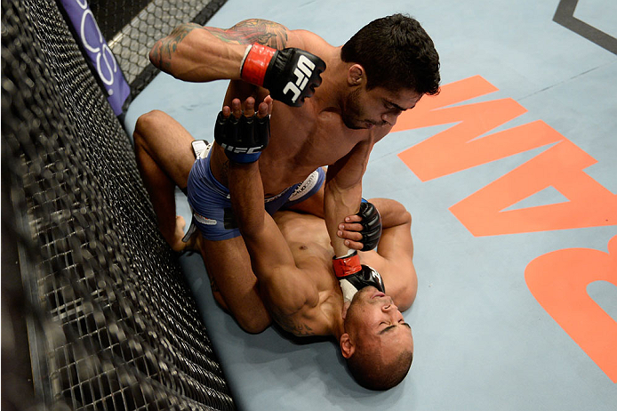 BANGOR, ME - AUGUST 16: (L-R) Thiago Tavares controls the body of Robbie Peralta in their featherweight bout during the UFC fight night event at the Cross Insurance Center on August 16, 2014 in Bangor, Maine. (Photo by Jeff Bottari/Zuffa LLC/Zuffa LLC vi