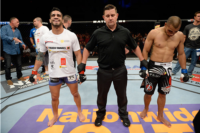 BANGOR, ME - AUGUST 16: (L-R) Thiago Tavares celebrates after defeating Robbie Peralta in their featherweight bout during the UFC fight night event at the Cross Insurance Center on August 16, 2014 in Bangor, Maine. (Photo by Jeff Bottari/Zuffa LLC/Zuffa