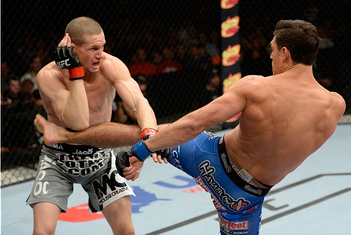 BANGOR, ME - AUGUST 16: (R-L) Alan Jouban kicks Seth Baczynski in their welterweight bout during the UFC fight night event at the Cross Insurance Center on August 16, 2014 in Bangor, Maine. (Photo by Jeff Bottari/Zuffa LLC/Zuffa LLC via Getty Images)