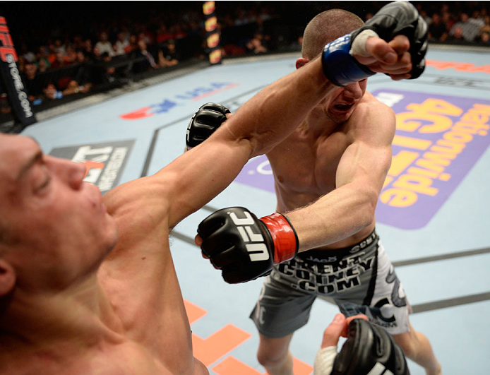 BANGOR, ME - AUGUST 16: (L-R) Alan Jouban punches Seth Baczynski in their welterweight bout during the UFC fight night event at the Cross Insurance Center on August 16, 2014 in Bangor, Maine. (Photo by Jeff Bottari/Zuffa LLC/Zuffa LLC via Getty Images)