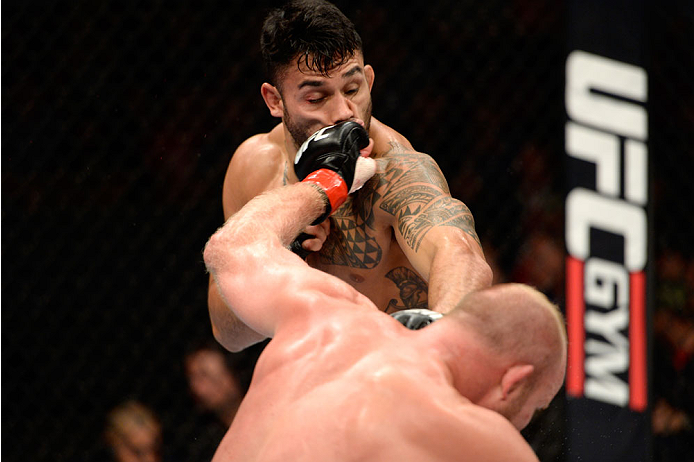 BANGOR, ME - AUGUST 16: (L-R) Tim Boetsch lands a punch to the face of Brad Tavares in their middleweight bout during the UFC fight night event at the Cross Insurance Center on August 16, 2014 in Bangor, Maine. (Photo by Jeff Bottari/Zuffa LLC/Zuffa LLC