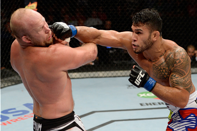 BANGOR, ME - AUGUST 16: (R-L) Brad Tavares punches Tim Boetsch in their middleweight bout during the UFC fight night event at the Cross Insurance Center on August 16, 2014 in Bangor, Maine. (Photo by Jeff Bottari/Zuffa LLC/Zuffa LLC via Getty Images)