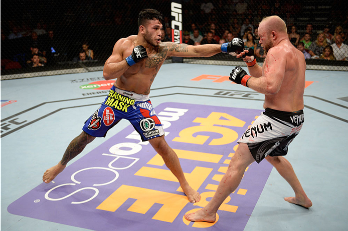 BANGOR, ME - AUGUST 16: (L-R) Brad Tavares punches Tim Boetsch in their middleweight bout during the UFC fight night event at the Cross Insurance Center on August 16, 2014 in Bangor, Maine. (Photo by Jeff Bottari/Zuffa LLC/Zuffa LLC via Getty Images)