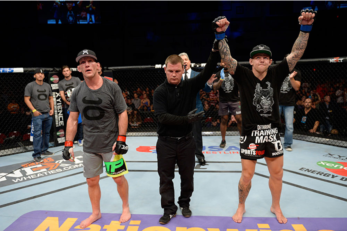 BANGOR, ME - AUGUST 16: (R-L) Ross Pearson celebrates after knocking out Gray Maynard in their lightweight bout during the UFC fight night event at the Cross Insurance Center on August 16, 2014 in Bangor, Maine. (Photo by Jeff Bottari/Zuffa LLC/Zuffa LLC