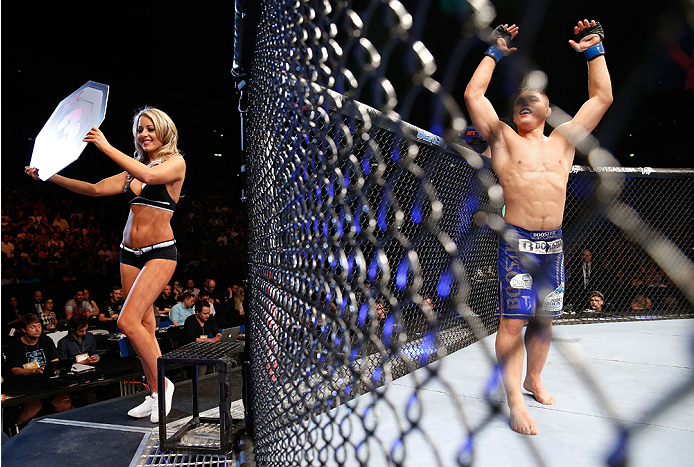 BERLIN, GERMANY - MAY 31: Drew Dober (R) enters the octagon as Octagon Girl Carly Baker poses during the Drew Dober vs. Nick Hein at UFC Fight Night Berlin event at O2 World on May 31, 2014 in Berlin, Germany. (Photo by Boris Streubel/Zuffa LLC/Zuffa LL