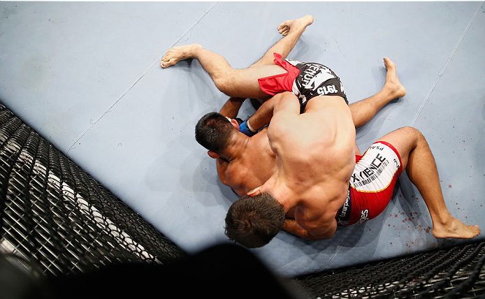 BERLIN, GERMANY - MAY 31: Gegard Mousasi (Bottom) fights Mark Munoz during the Gegard Mousasi vs. Mark Munoz match at UFC Fight Night Berlin event at O2 World on May 31, 2014 in Berlin, Germany. (Photo by Boris Streubel/Zuffa LLC/Zuffa LLC via Getty Imag