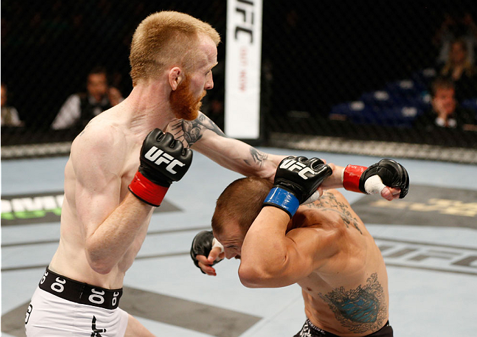 DUBLIN, IRELAND - JULY 19: (L-R) Patrick Holohan punches Josh Sampo in their flyweight bout during the UFC Fight Night event at The O2 Dublin on July 19, 2014 in Dublin, Ireland. (Photo by Josh Hedges/Zuffa LLC/Zuffa LLC via Getty Images)