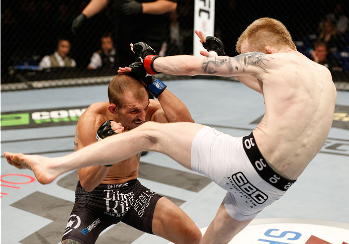 DUBLIN, IRELAND - JULY 19: (R-L) Patrick Holohan kicks Josh Sampo in their flyweight bout during the UFC Fight Night event at The O2 Dublin on July 19, 2014 in Dublin, Ireland. (Photo by Josh Hedges/Zuffa LLC/Zuffa LLC via Getty Images)