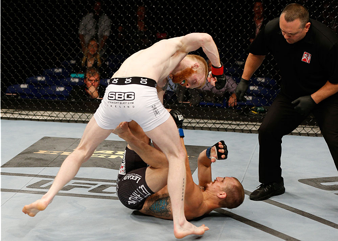 DUBLIN, IRELAND - JULY 19: (L-R) Patrick Holohan punches Josh Sampo in their flyweight bout during the UFC Fight Night event at The O2 Dublin on July 19, 2014 in Dublin, Ireland. (Photo by Josh Hedges/Zuffa LLC/Zuffa LLC via Getty Images)