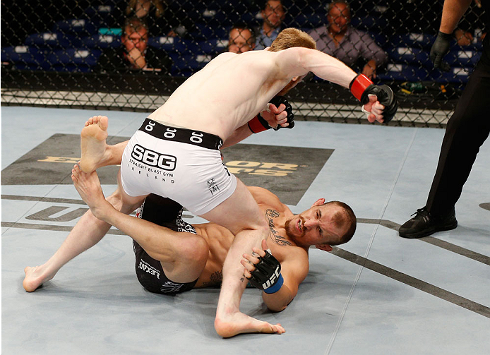 DUBLIN, IRELAND - JULY 19: (L-R) Patrick Holohan punches Josh Sampo in their flyweight bout during the UFC Fight Night event at The O2 Dublin on July 19, 2014 in Dublin, Ireland. (Photo by Josh Hedges/Zuffa LLC/Zuffa LLC via Getty Images)