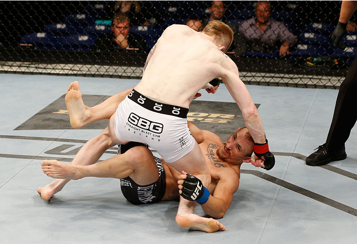DUBLIN, IRELAND - JULY 19: (L-R) Patrick Holohan punches Josh Sampo in their flyweight bout during the UFC Fight Night event at The O2 Dublin on July 19, 2014 in Dublin, Ireland. (Photo by Josh Hedges/Zuffa LLC/Zuffa LLC via Getty Images)