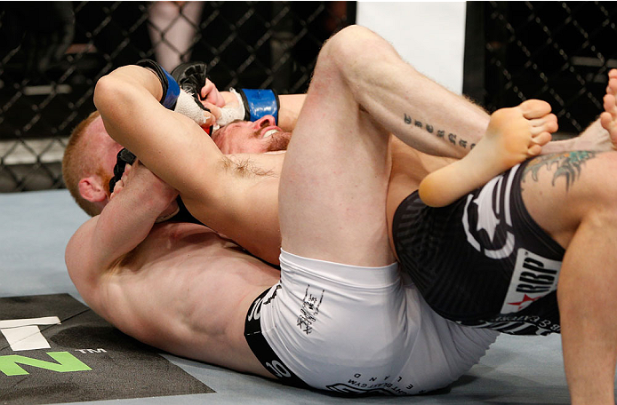 DUBLIN, IRELAND - JULY 19: (L-R) Patrick Holohan secures a rear choke submission against Josh Sampo in their flyweight bout during the UFC Fight Night event at The O2 Dublin on July 19, 2014 in Dublin, Ireland. (Photo by Josh Hedges/Zuffa LLC/Zuffa LLC