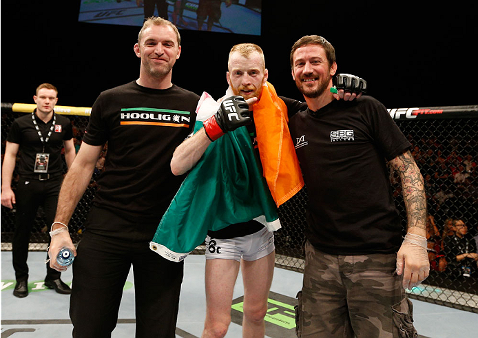 DUBLIN, IRELAND - JULY 19: Patrick Holohan (C) poses for a photo with his team after his submission victory over Josh Sampo in their flyweight bout during the UFC Fight Night event at The O2 Dublin on July 19, 2014 in Dublin, Ireland. (Photo by Josh Hed