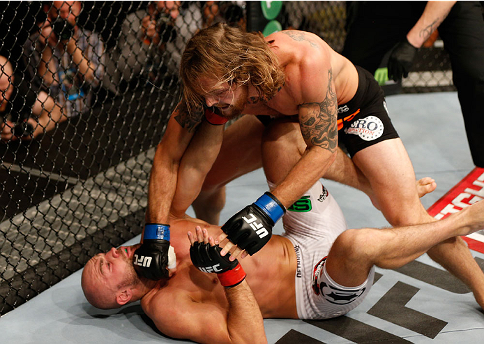 DUBLIN, IRELAND - JULY 19: (R-L) Mike King lands a right to the head of Cathal Pendred in their middleweight bout during the UFC Fight Night event at The O2 Dublin on July 19, 2014 in Dublin, Ireland. (Photo by Josh Hedges/Zuffa LLC/Zuffa LLC via Getty