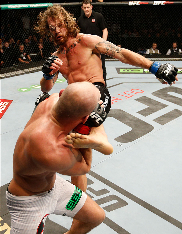 DUBLIN, IRELAND - JULY 19: Mike King (black trunks) lands a kick against Cathal Pendred in their middleweight bout during the UFC Fight Night event at The O2 Dublin on July 19, 2014 in Dublin, Ireland. (Photo by Josh Hedges/Zuffa LLC/Zuffa LLC via Getty