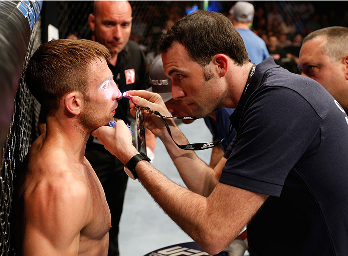 DUBLIN, IRELAND - JULY 19: Phil Harris is checked by a doctor after the first round of his flyweight bout against Neil Seery during the UFC Fight Night event at The O2 Dublin on July 19, 2014 in Dublin, Ireland. (Photo by Josh Hedges/Zuffa LLC/Zuffa LLC