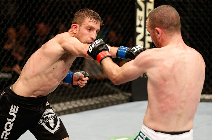 DUBLIN, IRELAND - JULY 19: (L-R) Phil Harris connects with a left against Neil Seery in their flyweight bout during the UFC Fight Night event at The O2 Dublin on July 19, 2014 in Dublin, Ireland. (Photo by Josh Hedges/Zuffa LLC/Zuffa LLC via Getty Image