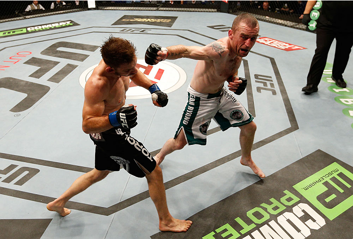 DUBLIN, IRELAND - JULY 19: (R-L) Neil Seery connects with a right hook to the head of Phil Harris in their flyweight bout during the UFC Fight Night event at The O2 Dublin on July 19, 2014 in Dublin, Ireland. (Photo by Josh Hedges/Zuffa LLC/Zuffa LLC vi