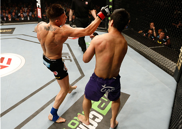 DUBLIN, IRELAND - JULY 19: (L-R) Norman Parke delivers an uppercut against Naoyuki Kotani in their lightweight bout during the UFC Fight Night event at The O2 Dublin on July 19, 2014 in Dublin, Ireland. (Photo by Josh Hedges/Zuffa LLC/Zuffa LLC via Gett