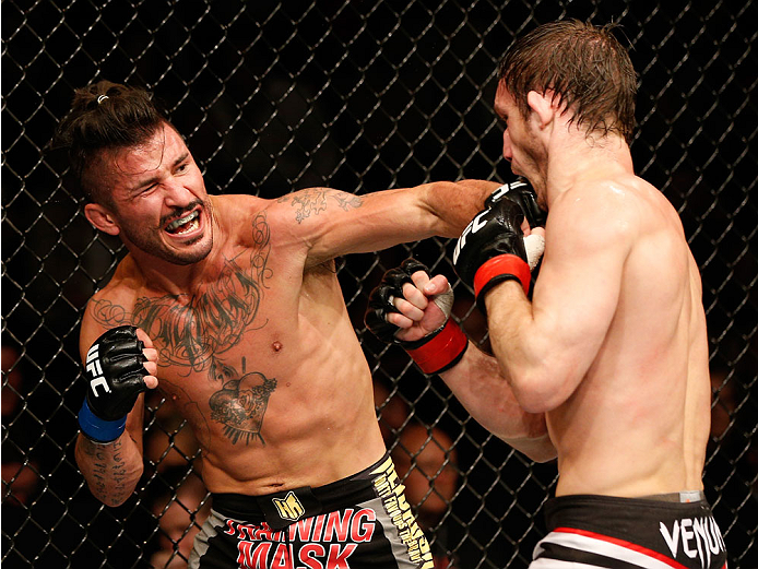 DUBLIN, IRELAND - JULY 19: (L-R) Ian McCall connects with a left against Brad Pickett in their flyweight bout during the UFC Fight Night event at The O2 Dublin on July 19, 2014 in Dublin, Ireland. (Photo by Josh Hedges/Zuffa LLC/Zuffa LLC via Getty Imag