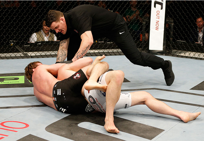 DUBLIN, IRELAND - JULY 19: (L-R) Gunnar Nelson secures a rear choke submission against Zak Cummings in their welterweight bout during the UFC Fight Night event at The O2 Dublin on July 19, 2014 in Dublin, Ireland. (Photo by Josh Hedges/Zuffa LLC/Zuffa L