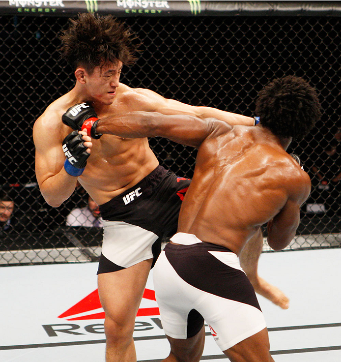 SEOUL, SOUTH KOREA - NOVEMBER 28: (From L to R) Dong Hyun Kim of South Korea and Dominique Steele of the United States of America exchange strikes in their lightweight bout during the UFC Fight Night at the Olympic Park Gymnastics Arena on November 28,