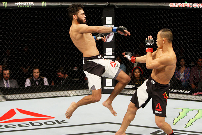 SEOUL, SOUTH KOREA - NOVEMBER 28: Marco Beltran of Mexico throws a kick on Ning Guangyou of China in their bantamweight bout during the UFC Fight Night at the Olympic Park Gymnastics Arena on November 28, 2015 in Seoul, South Korea. (Photo by Mitch Vique