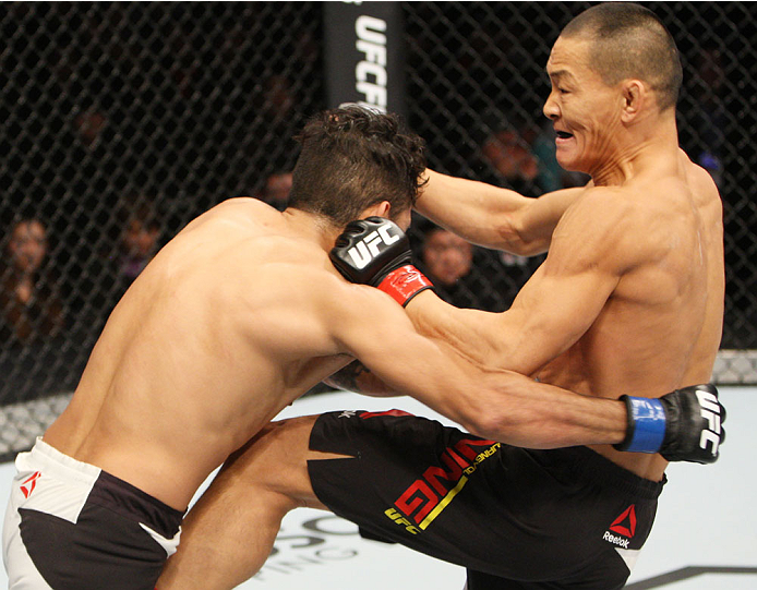 SEOUL, SOUTH KOREA - NOVEMBER 28: Ning Guangyou of China throws a punch at Marco Beltran of Mexico in their bantamweight bout during the UFC Fight Night at the Olympic Park Gymnastics Arena on November 28, 2015 in Seoul, South Korea. (Photo by Mitch Vique