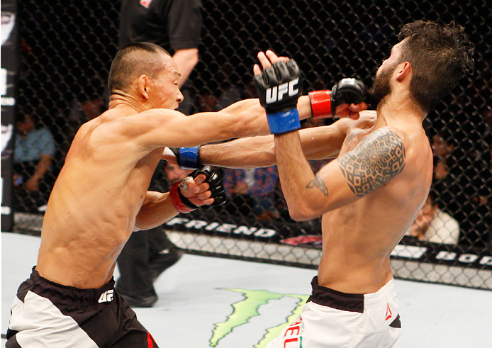 SEOUL, SOUTH KOREA - NOVEMBER 28: Ning Guangyou of China punches Marco Beltran of Mexico in their bantamweight bout during the UFC Fight Night at the Olympic Park Gymnastics Arena on November 28, 2015 in Seoul, South Korea. (Photo by Mitch Viquez/Zuffa L