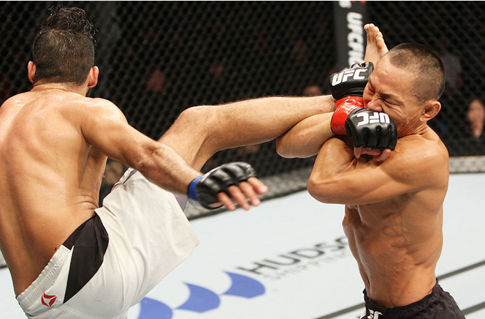 SEOUL, SOUTH KOREA - NOVEMBER 28: Ning Guangyou of China catches a kick and looks for a takedown on Marco Beltran of Mexico in their bantamweight bout during the UFC Fight Night at the Olympic Park Gymnastics Arena on November 28, 2015 in Seoul, South Ko
