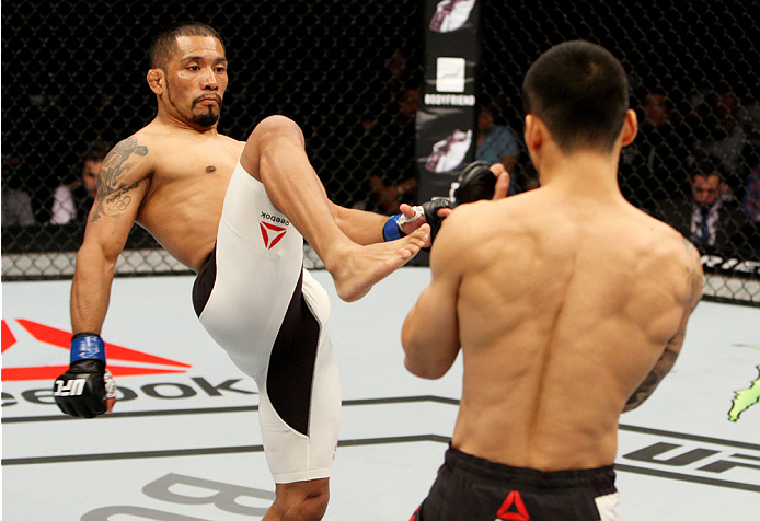 SEOUL, SOUTH KOREA - NOVEMBER 28: Fredy Serrano of Colombia throws a kick on Yao Zhikui of China in their flyweight bout during the UFC Fight Night at the Olympic Park Gymnastics Arena on November 28, 2015 in Seoul, South Korea. (Photo by Mitch Viquez/Z