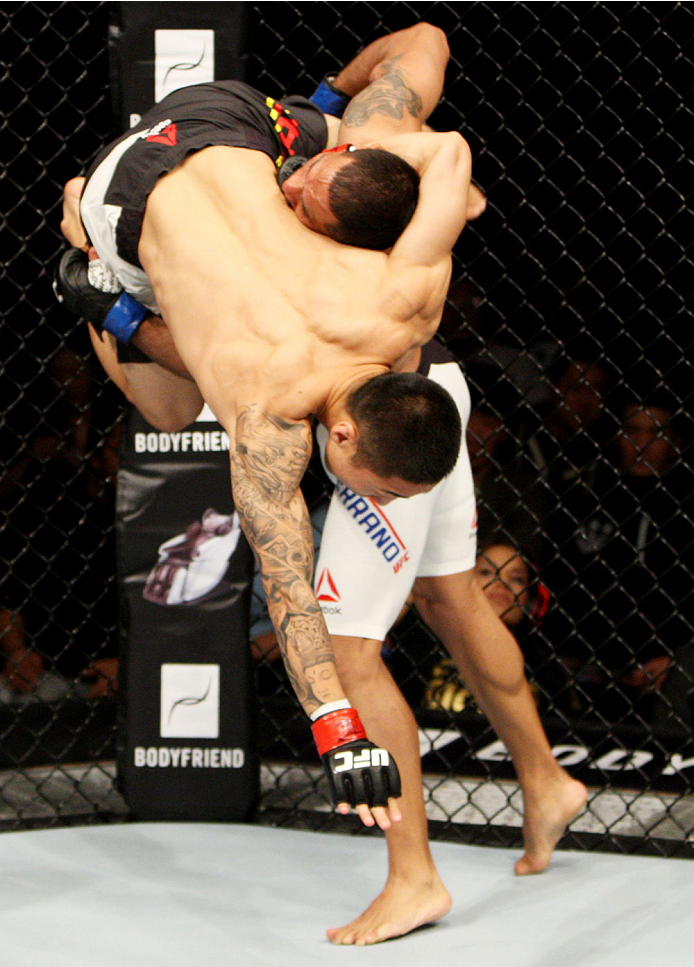 SEOUL, SOUTH KOREA - NOVEMBER 28: Fredy Serrano of Colombia goes for a takedown on Yao Zhikui of China in their flyweight bout during the UFC Fight Night at the Olympic Park Gymnastics Arena on November 28, 2015 in Seoul, South Korea. (Photo by Mitch Viq
