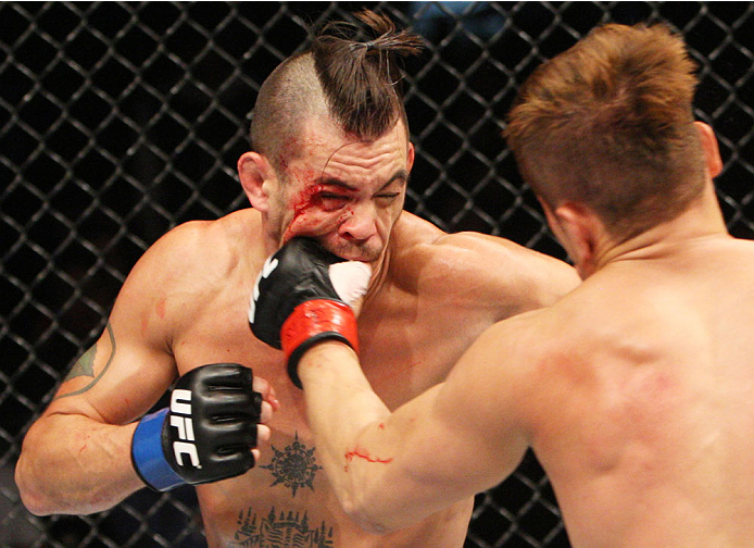 SEOUL, SOUTH KOREA - NOVEMBER 28: Tae Hyun Bang of South Korea punches Leo Kuntz of the United States of America in their lightweight bout during the UFC Fight Night at the Olympic Park Gymnastics Arena on November 28, 2015 in Seoul, South Korea. (Photo