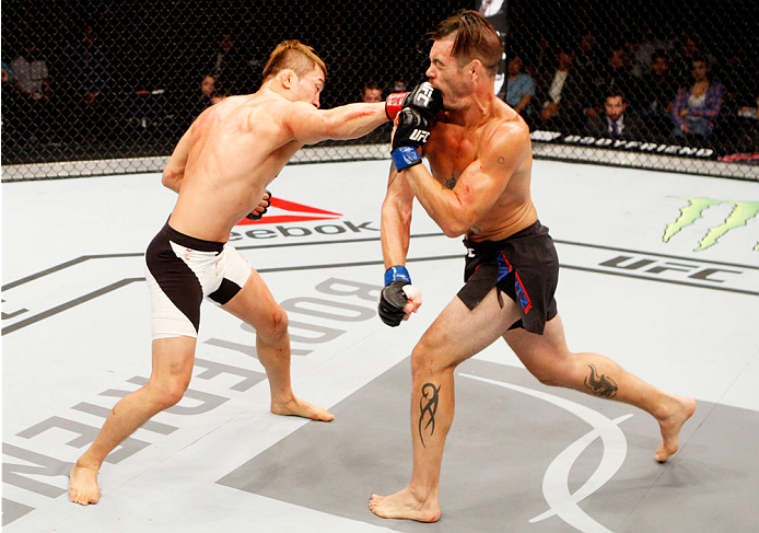 SEOUL, SOUTH KOREA - NOVEMBER 28: Tae Hyun Bang of South Korea punches Leo Kuntz of the United States of America in their lightweight bout during the UFC Fight Night at the Olympic Park Gymnastics Arena on November 28, 2015 in Seoul, South Korea. (Photo
